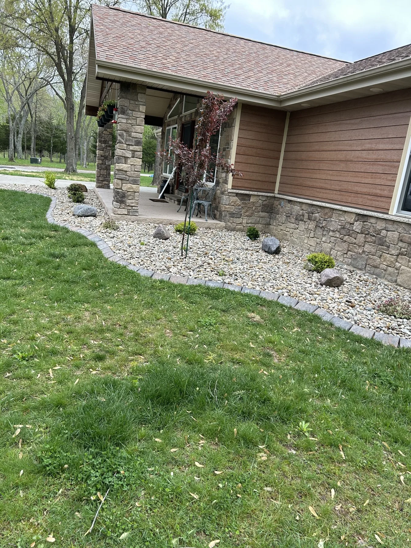 Fresh river-rock beds and plantings along a home