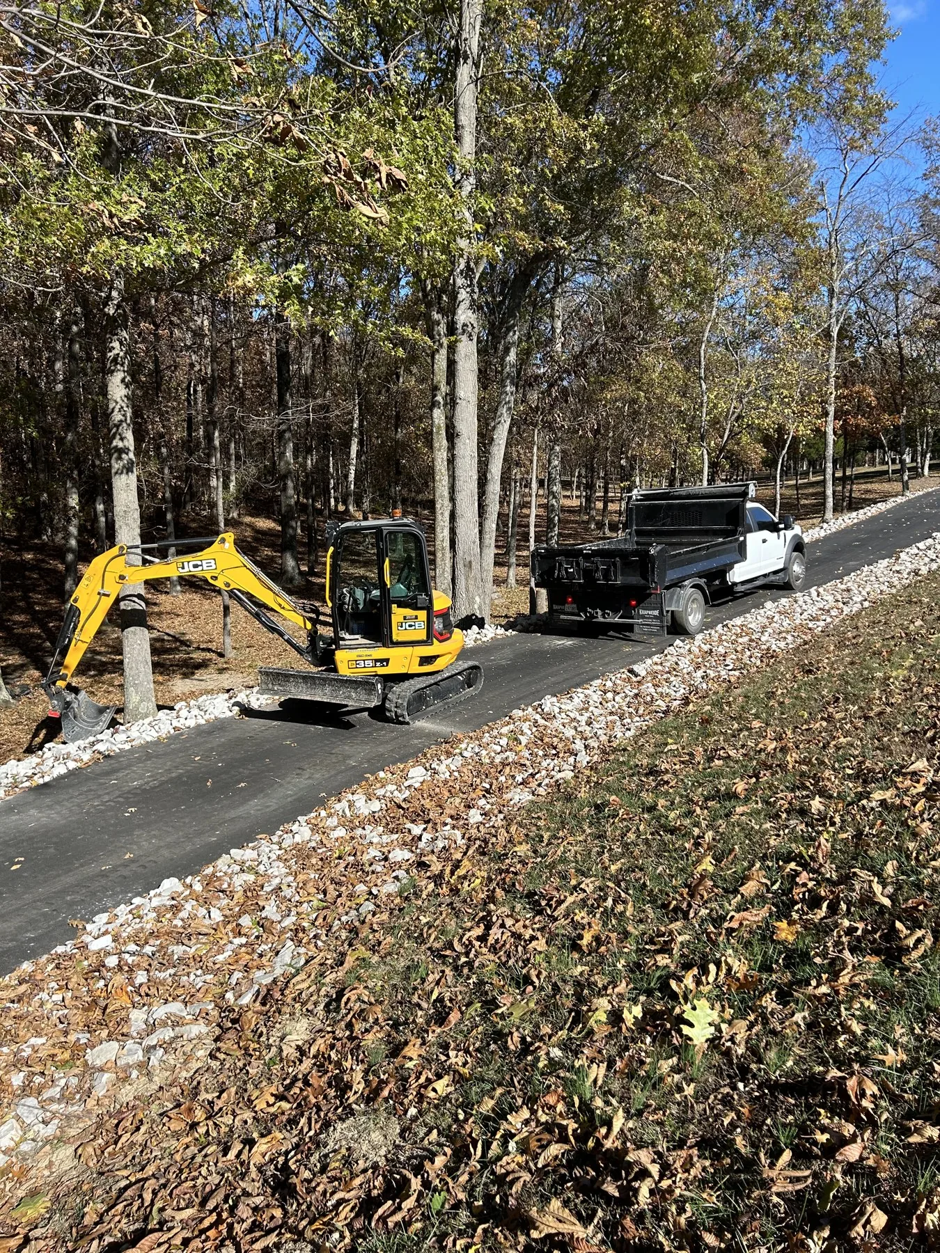 Compact excavator grading a commercial site